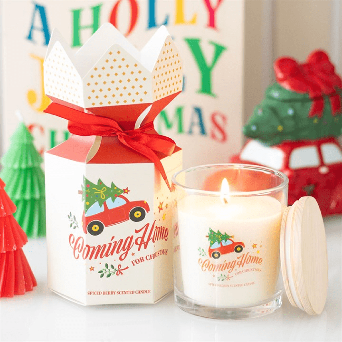 Coming Home for Christmas Spiced Berry Candles in decorative holder with festive packaging and holiday decor.