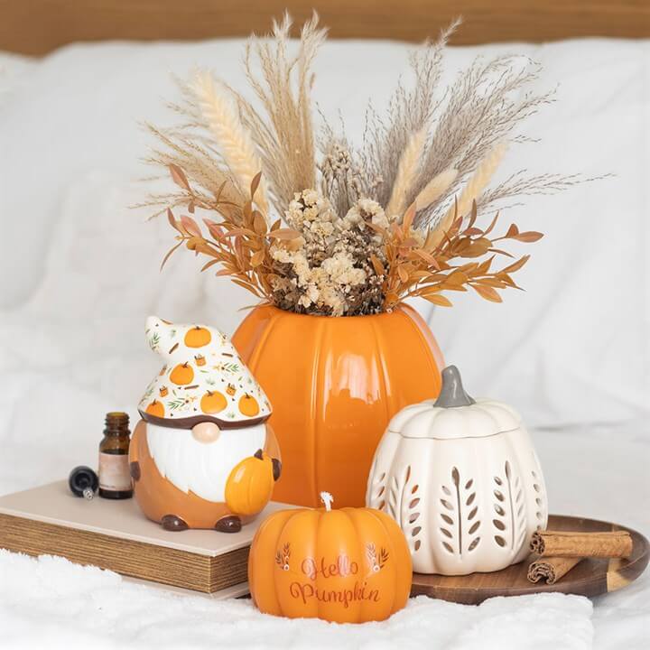 Cream Leaf Cut Out Pumpkin Oil Burner and Wax Warmer with autumn decor and pumpkin arrangements.