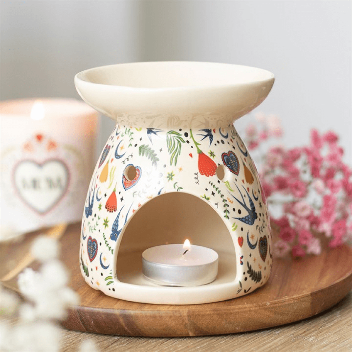 Cream Midnight Bloom Print Oil Burner with decorative floral design and lit tea light candle.
