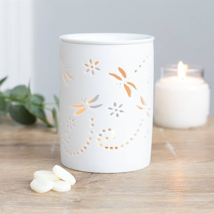 Cut Out Dragonfly Oil Burner with delicate dragonfly designs and soft glow from a tealight, enhancing home decor.