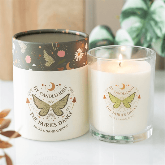 Fairy Wing Moss & Sandalwood Candles in elegant glass holders with intricate designs.