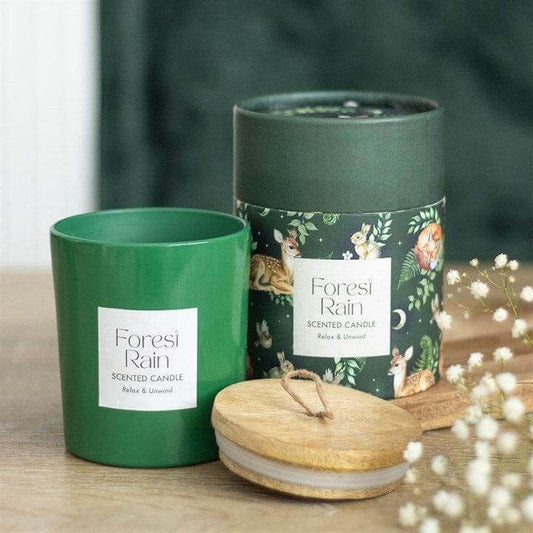 Forest Rain Woodland Scented Candle in green container with wooden lid and floral packaging.
