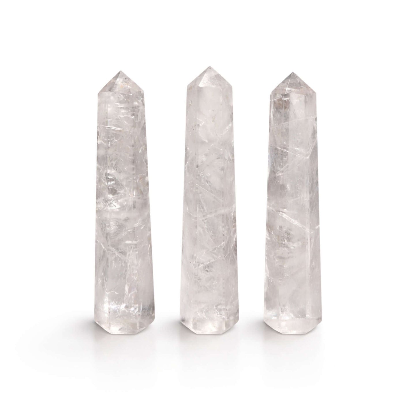 Gemstone Clear Quartz Six Face Obelisk Points arranged in a row, showcasing their polished finish and clarity.
