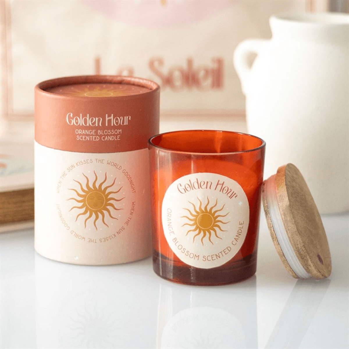 Golden Hour Orange Blossom Candles in amber jar and decorative box, perfect for a floral ambiance.