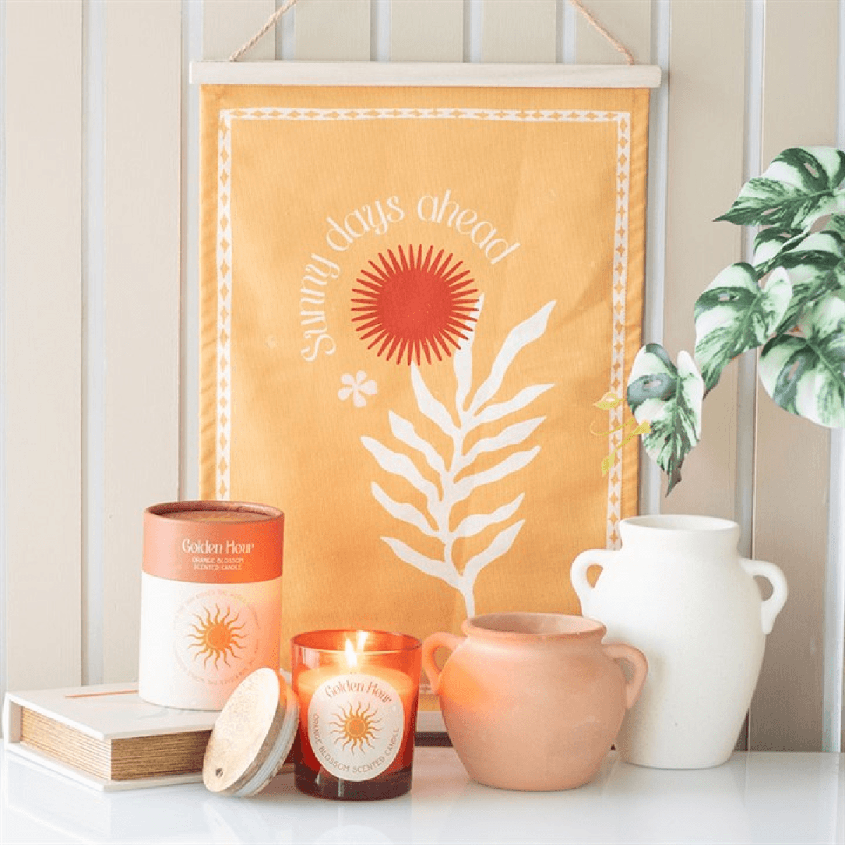 Golden Hour Orange Blossom Candles and decor in a bright, floral-themed home setting.