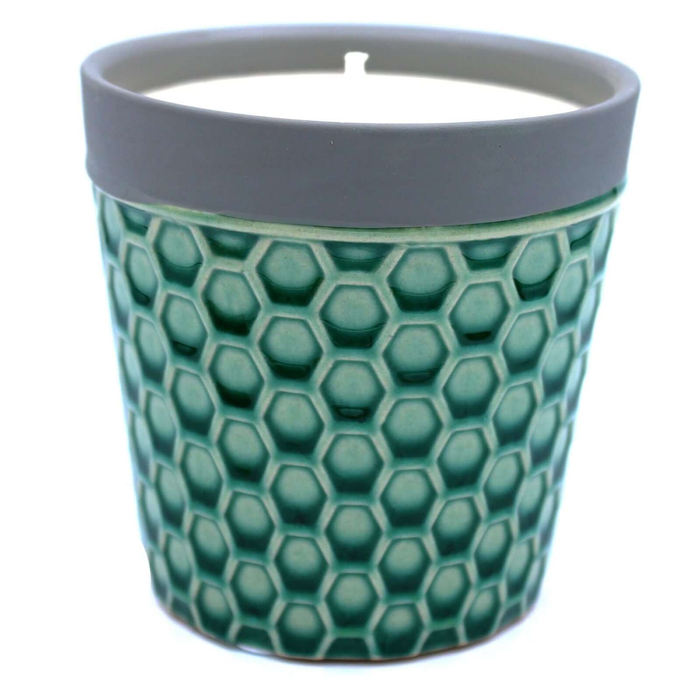 Home Candle in a green honeycomb patterned pot with a gray rim, showcasing its unique design and natural wax.