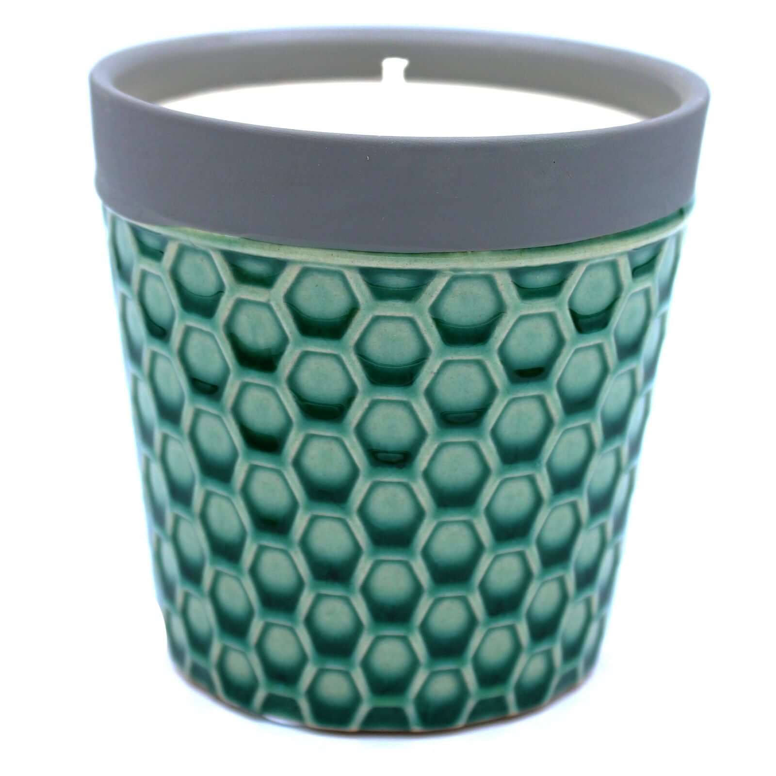 Home Candle in a green honeycomb patterned pot with a gray rim, showcasing its unique design and natural wax.