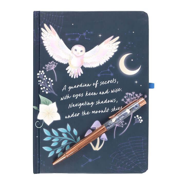 Notebook with owl illustration and pen on a white background