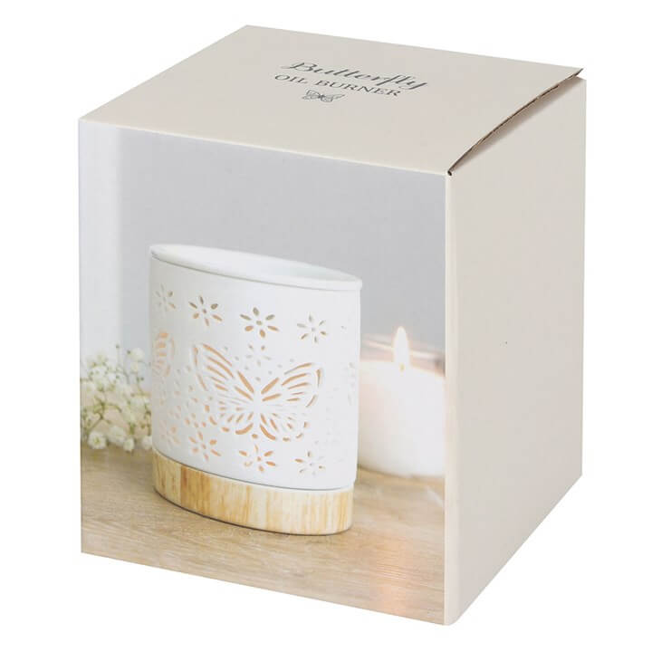 Matte Ceramic Butterfly Oil Burner displayed in packaging, showcasing delicate cut-outs and a candle.