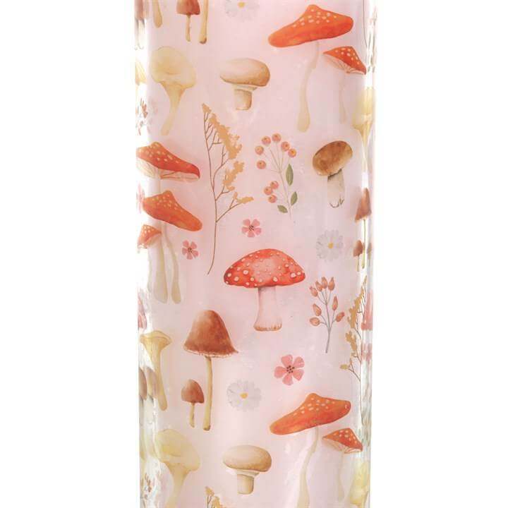 Mushroom print design on a tube candle, featuring various whimsical mushrooms and flowers, perfect for home decor.