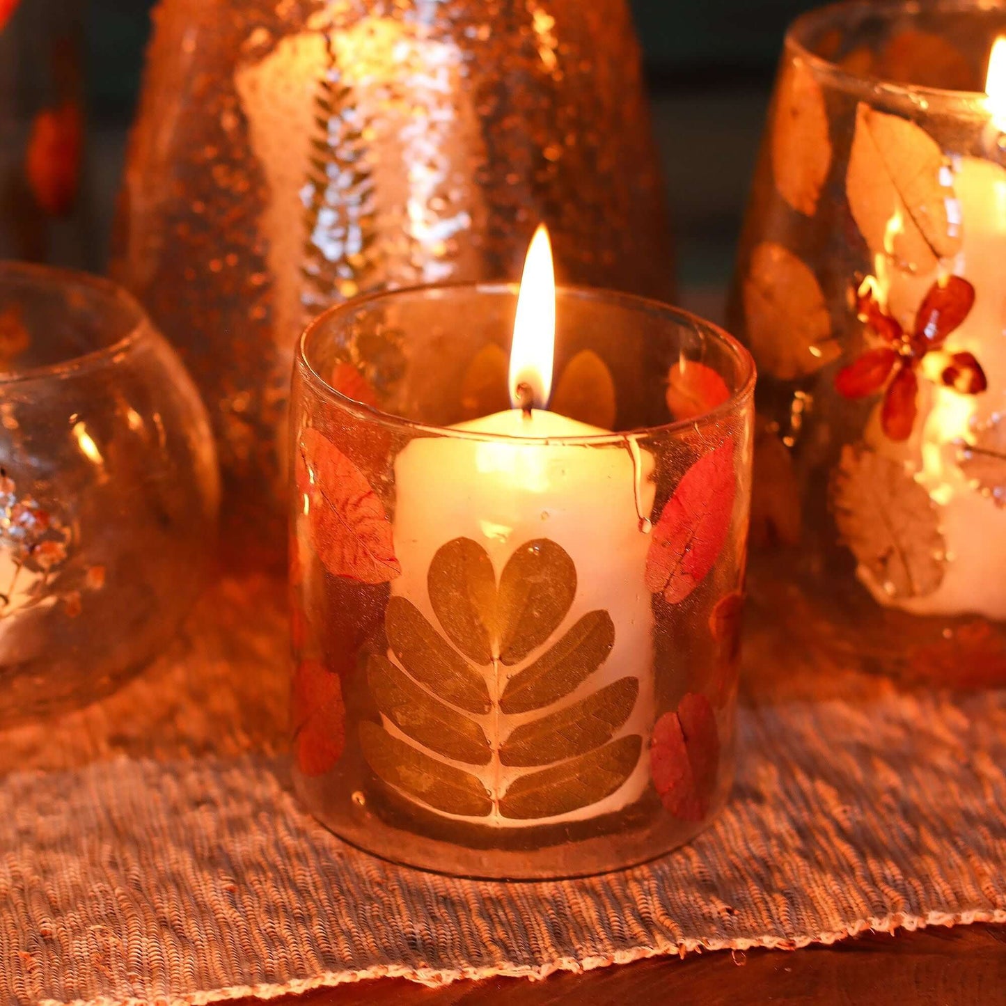Natural Floral Candle Holder showcasing pressed leaves and blossoms, lit with a tea light candle, 8x8cm size.