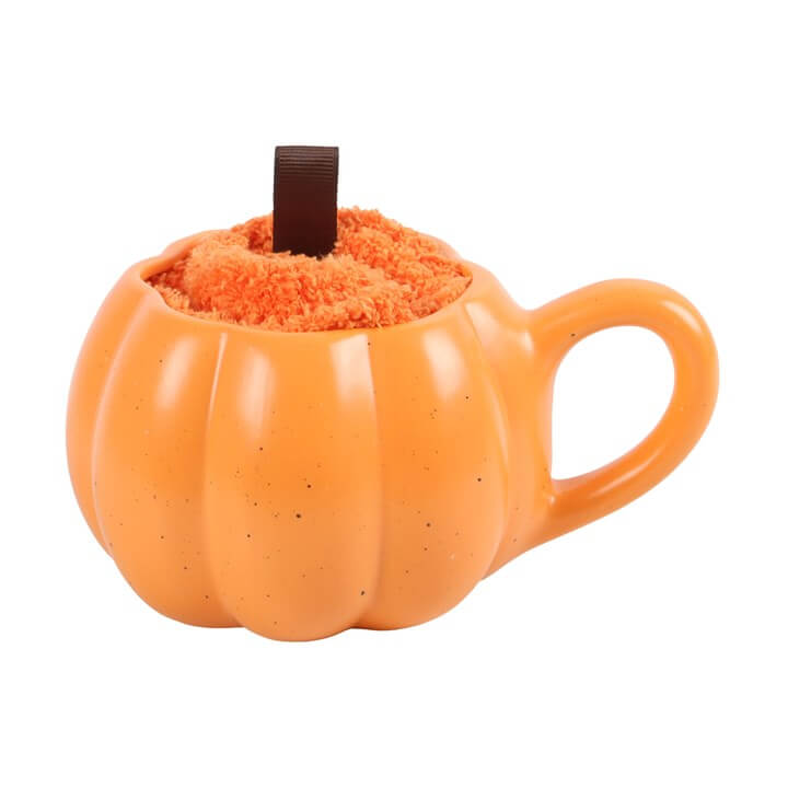 Pumpkin Shaped Mug and Socks Set featuring an orange mug filled with fluffy orange socks.