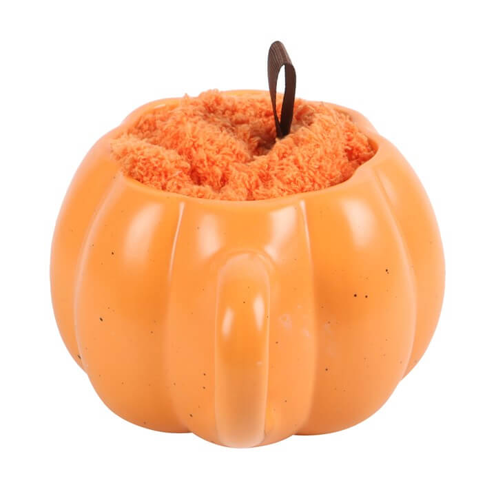 Pumpkin shaped mug from the Mug and Socks Set with fluffy orange interior and brown ribbon stem.
