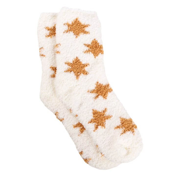 Cozy fluffy socks with a star pattern, perfect for warming up during winter evenings with a mug and socks set.
