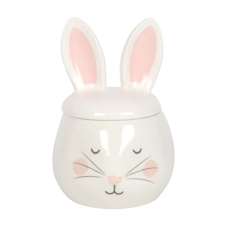 White ceramic jar with bunny design on a white background