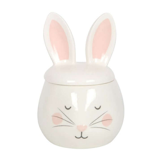 White ceramic jar with bunny design on a white background