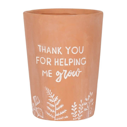 Terracotta pot with white text and floral designs on a white background