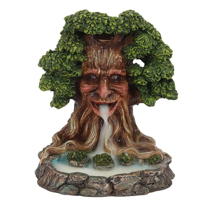 Statue of a tree-like creature with facial features and foliage on a white background