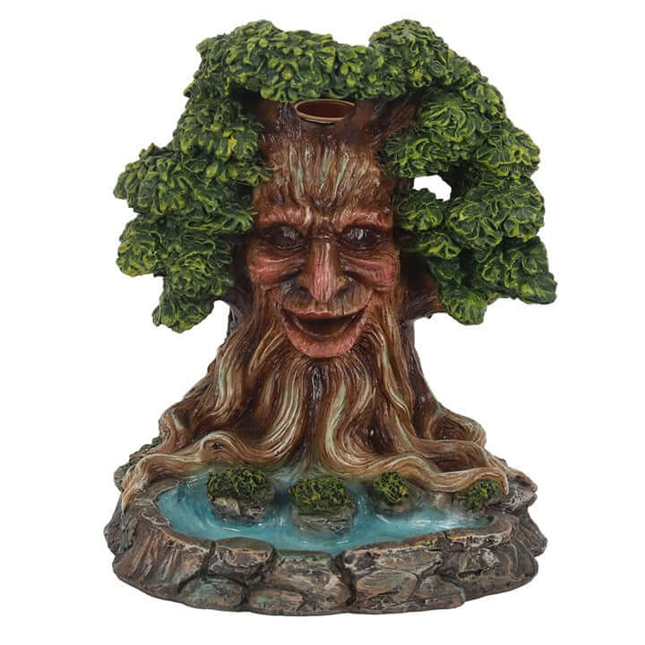 Tree-like figurine with face and foliage on a white background