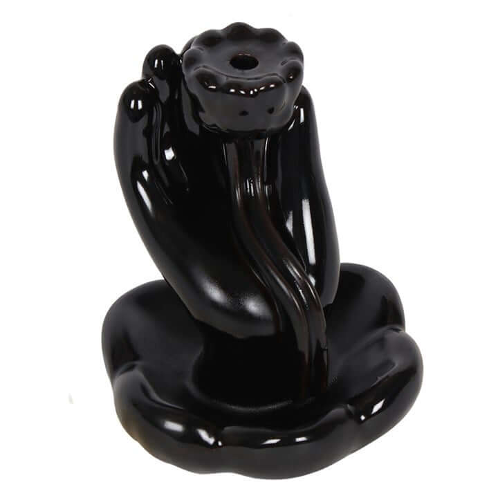 Black ceramic sculpture of a panther on a white background