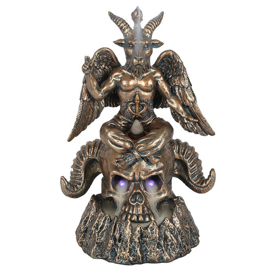 Bronze statue of a creature with wings and horns on a skull base against a white background