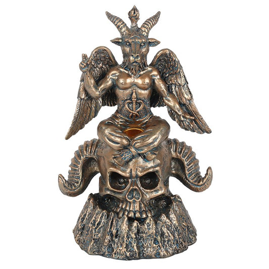 Bronze statue of a creature with wings and horns on a skull, on a white background
