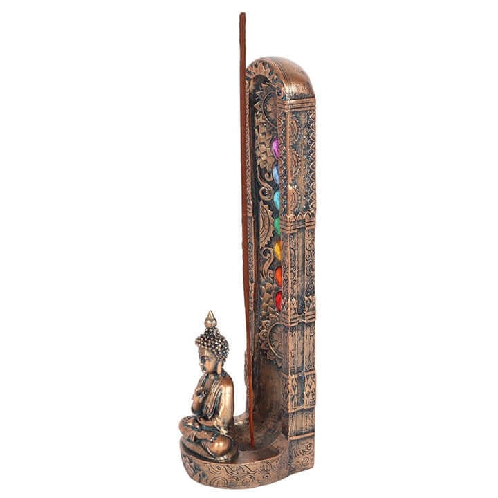 Decorative incense holder with Buddha statue and colorful beads on a white background