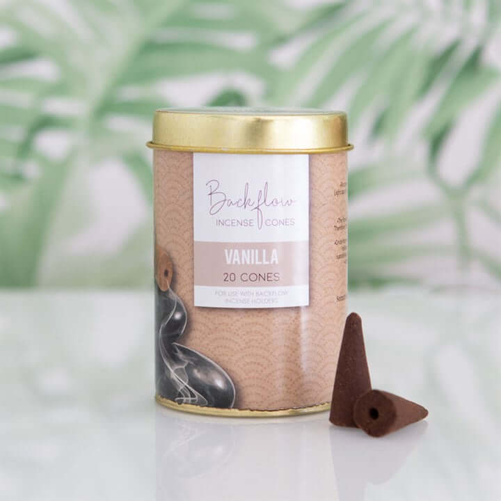 Vanilla-scented incense cones in a cardboard canister with a gold lid on a light background.
