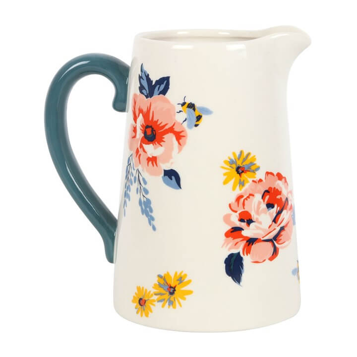 Ceramic pitcher with floral design on a white background