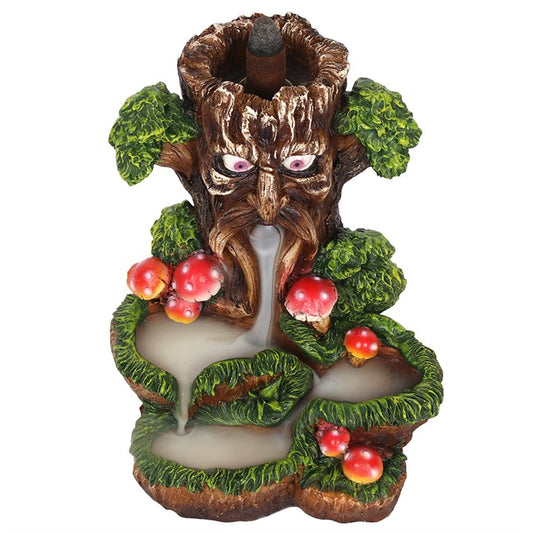 Decorative tree-like sculpture with facial features, leaves, and berries on a white background