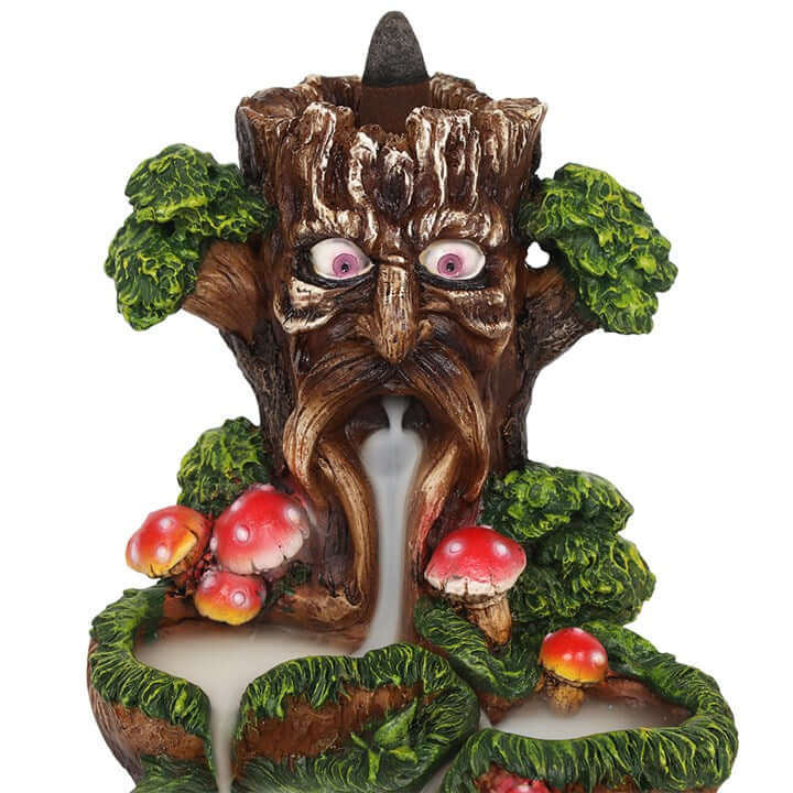 Tree-like figurine with eyes, nose, and mouth, surrounded by mushrooms on a white background