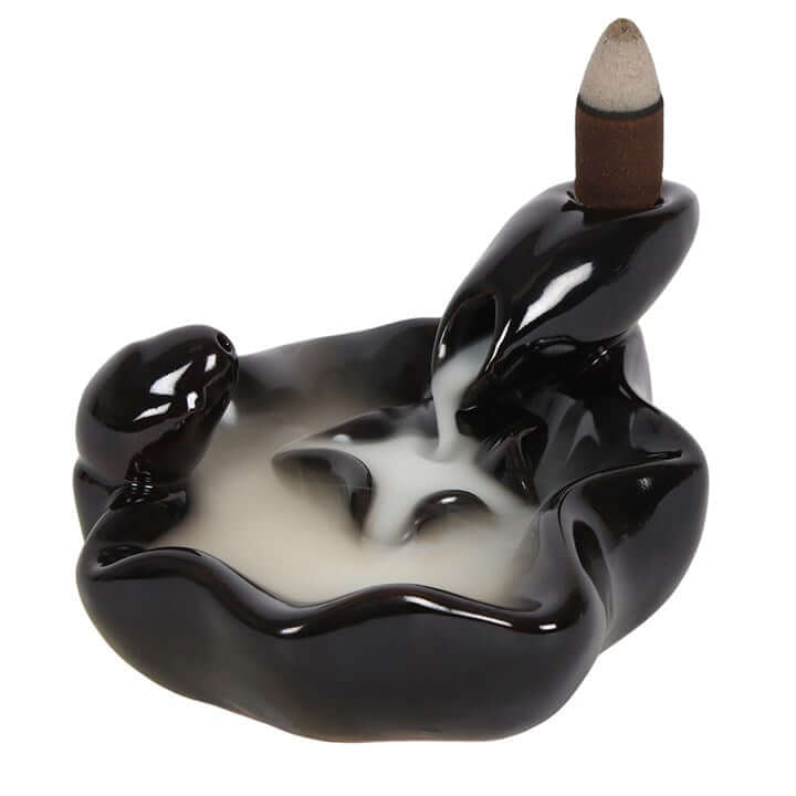 Ceramic incense burner shaped like a hand holding an incense stick on a white background