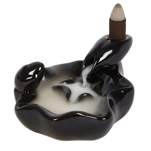 Ceramic incense burner shaped like a hand holding an incense stick on a white background