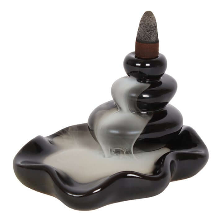 Cylindrical incense burner with wavy design on a white background