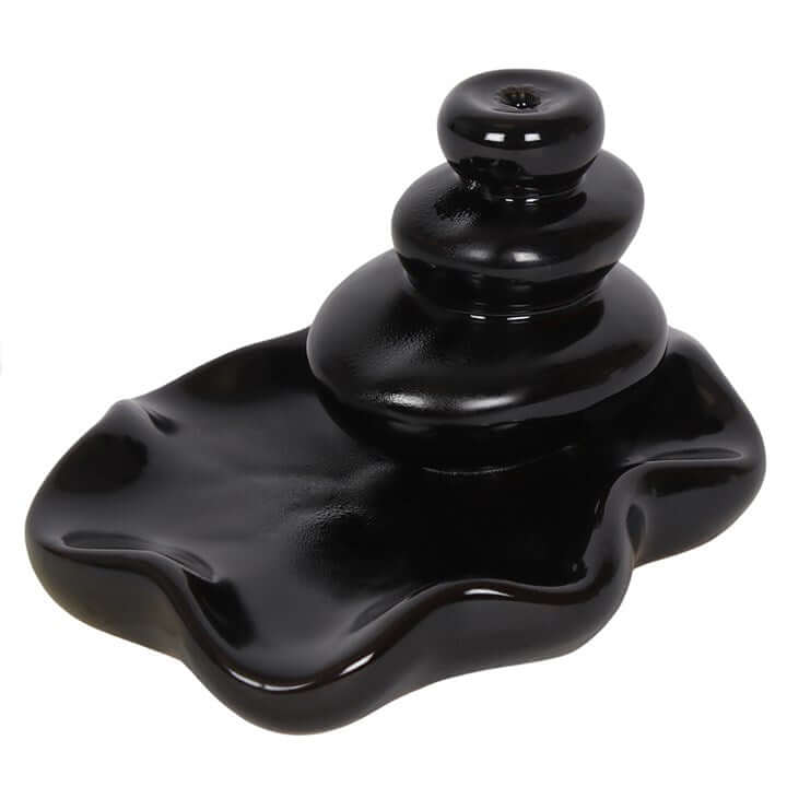 Black ceramic incense burner on a white background