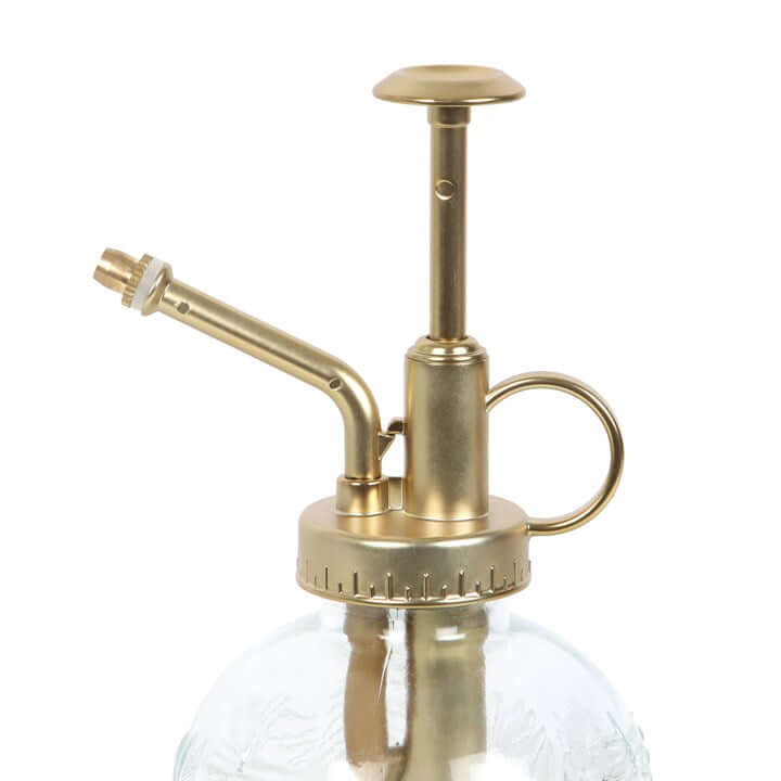 Brass and glass atomizer on a white background