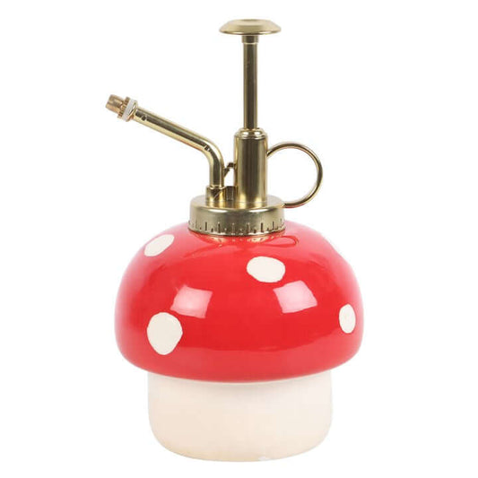 Mushroom-shaped spray bottle with red cap and white spots on a white background