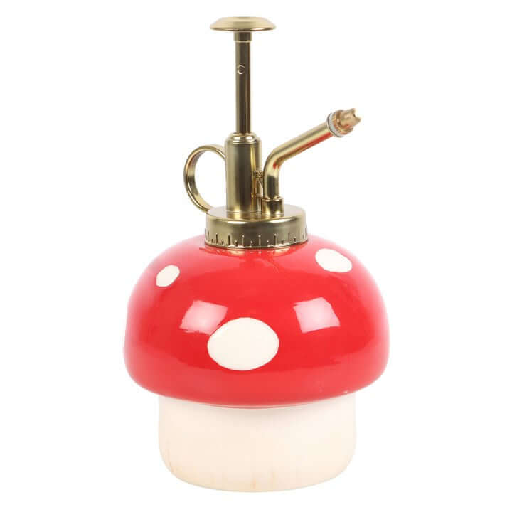 Mushroom-shaped spray bottle with red cap and white body on a white background