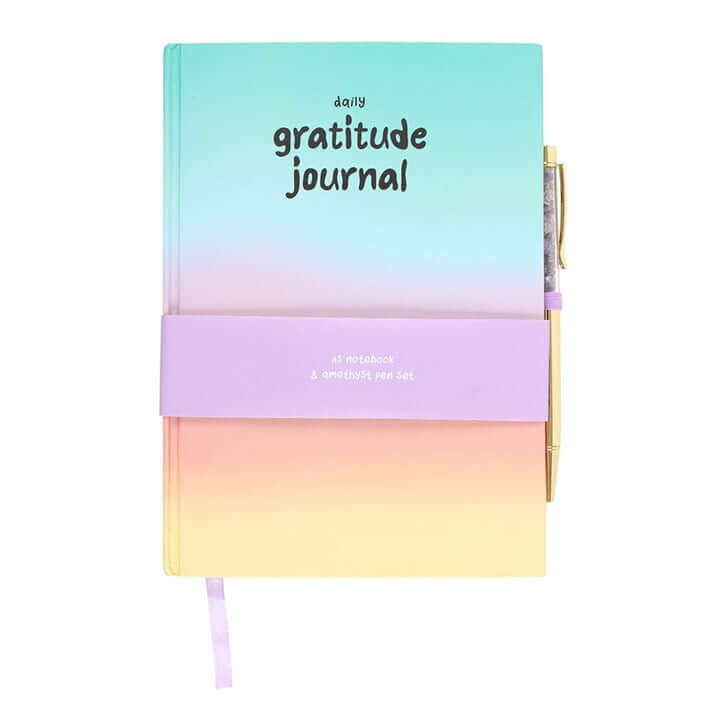 Gradient notebook with 'daily gratitude journal' text on a white background