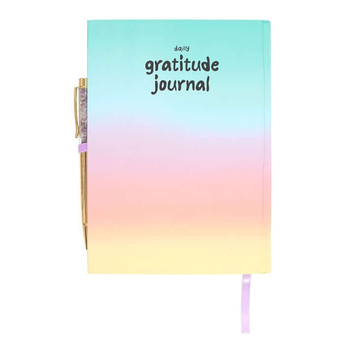 Gradient notebook with 'daily gratitude journal' text on a white background