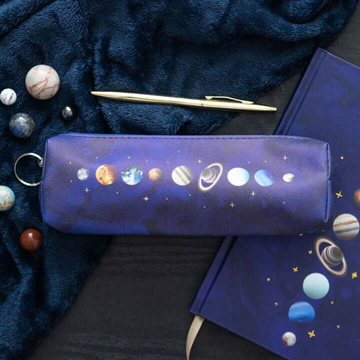 Pencil case with solar system design on a dark fabric background