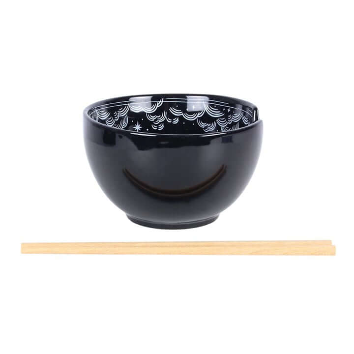 Spellbound Sky Noodle Bowl and Chopsticks Set featuring a black ceramic bowl and wooden chopsticks.
