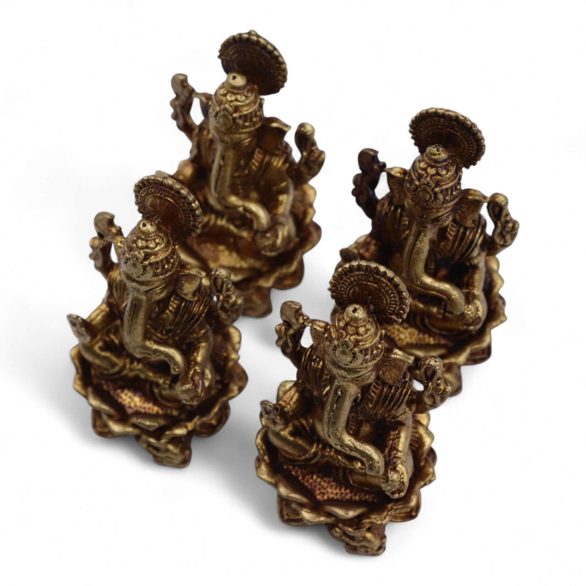 Four Brass Miniature Ganesha Gods statues with intricate detailing and lotus bases, handcrafted in India.