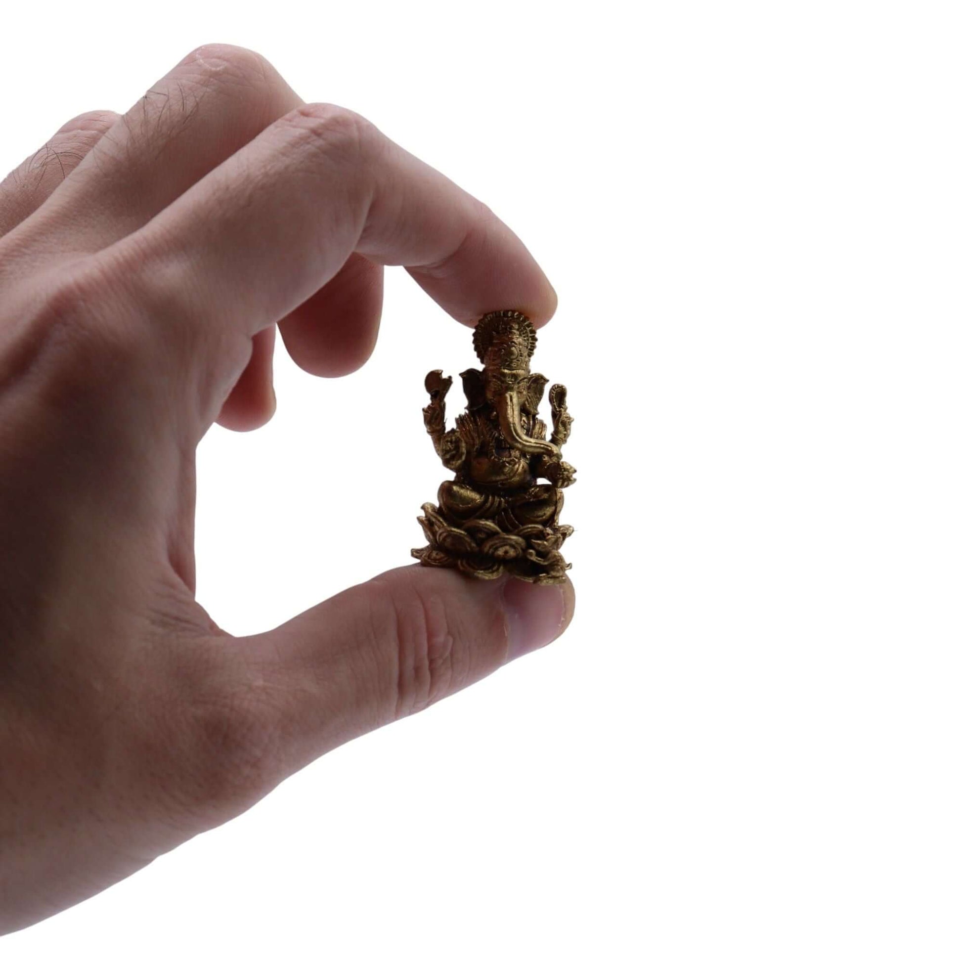 Hand holding a 37mm Brass Miniature Ganesha Gods figurine, symbolizing wisdom and prosperity.