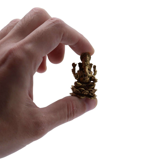 Hand holding a 37mm Brass Miniature Ganesha Gods figurine, symbolizing wisdom and prosperity.