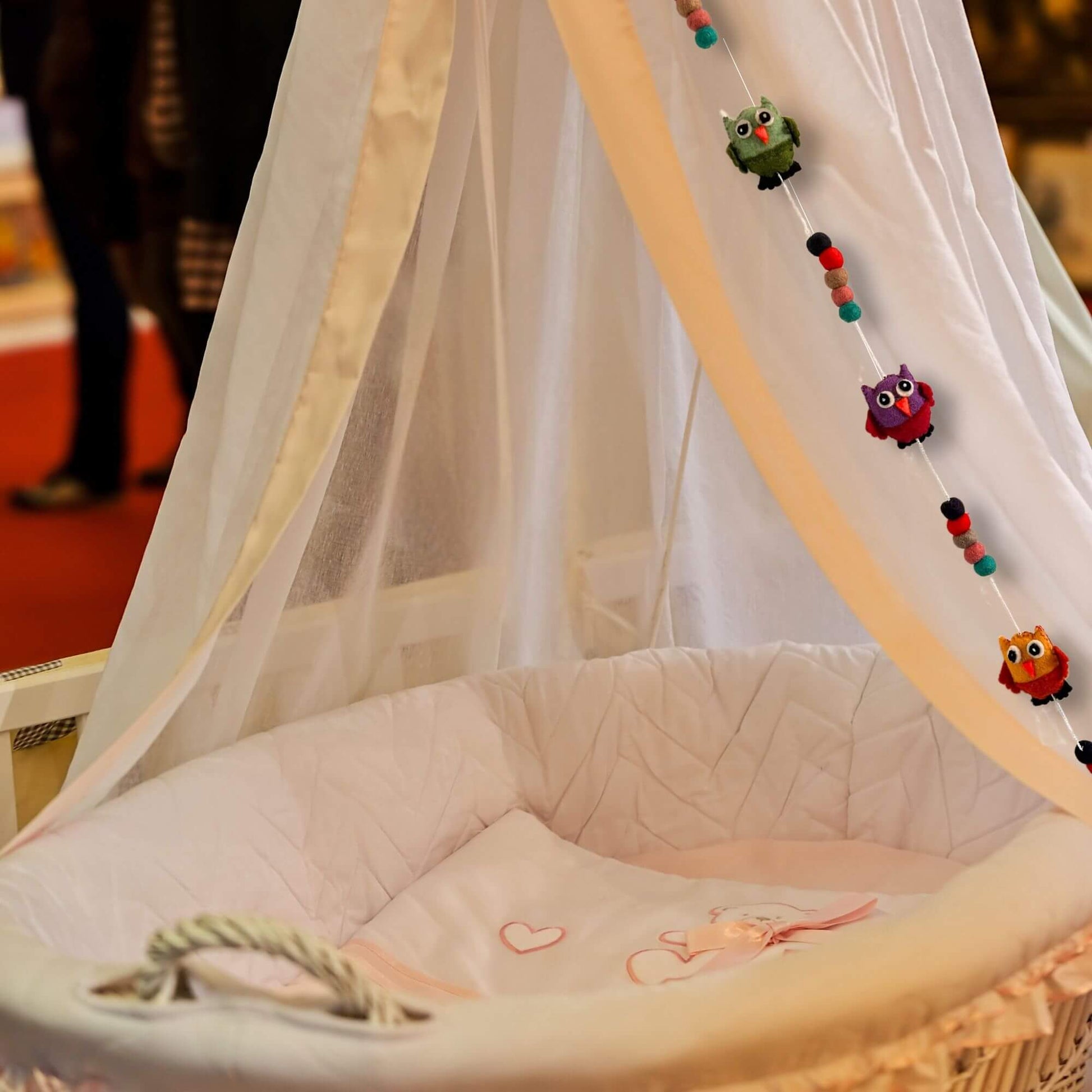 Felt Wall Hanging Owls decoration on a crib canopy with colorful owls and playful design.