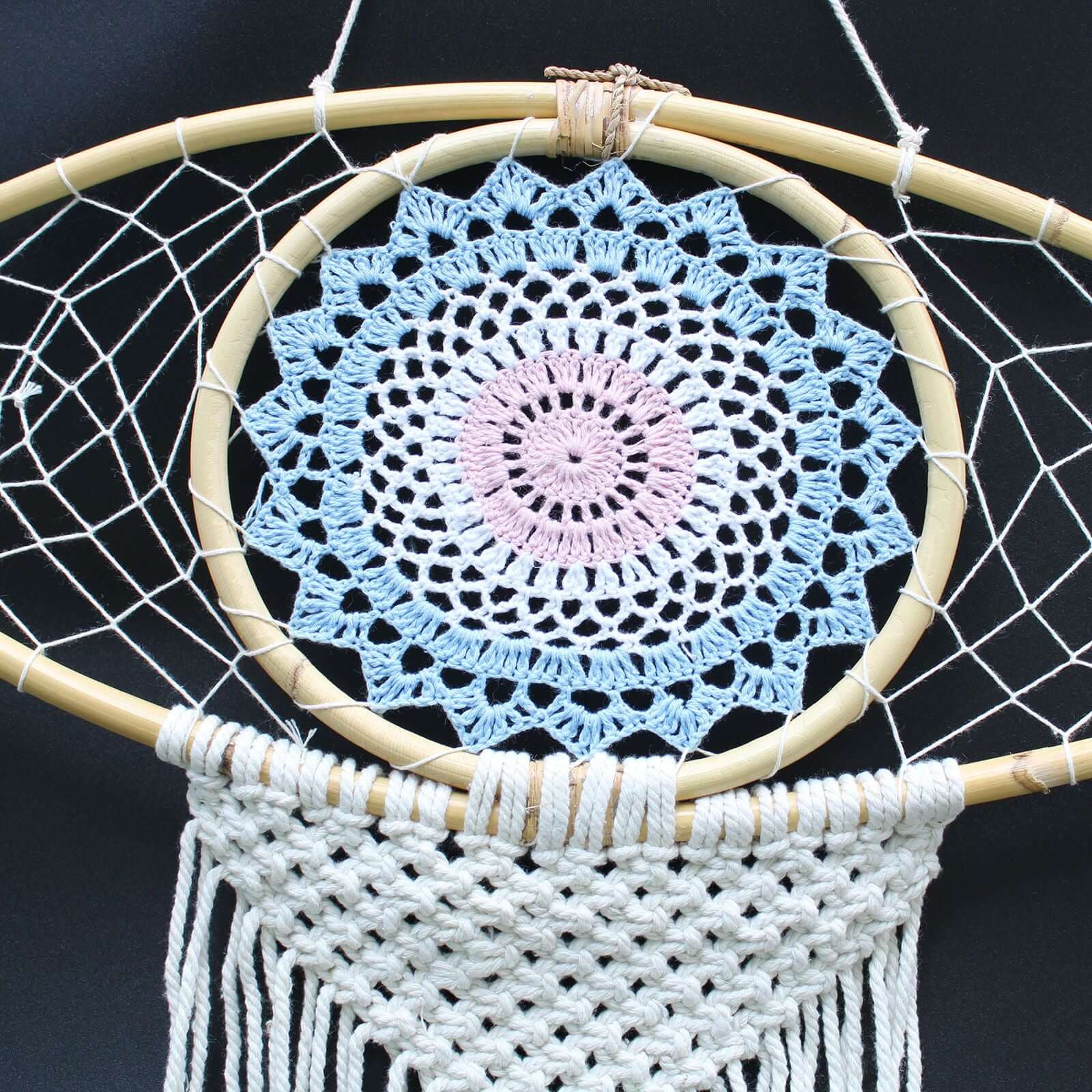 Protection Dream Catcher made of macrame with a blue and pink crochet design and white fringe detail.