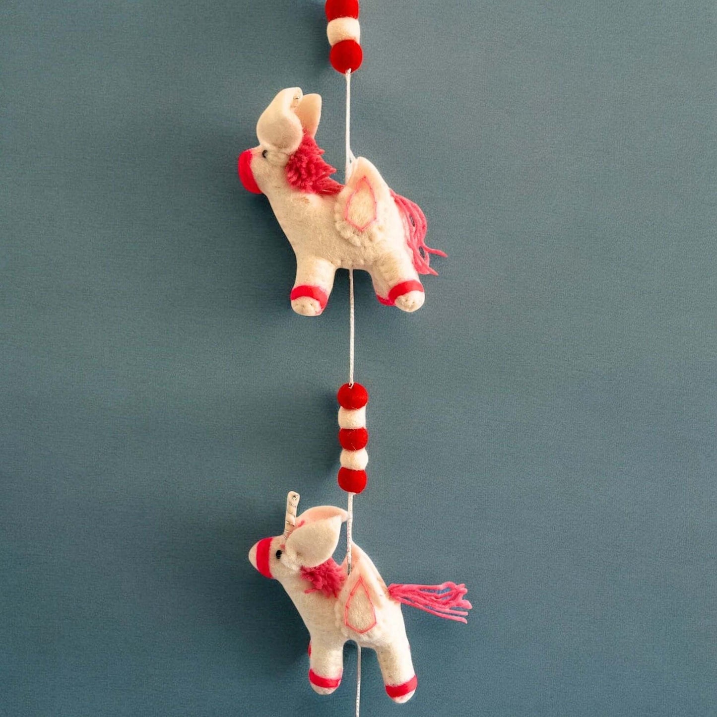 Felt Wall Hanging Unicorns featuring cute plush unicorns in vibrant colors for children's room decor.