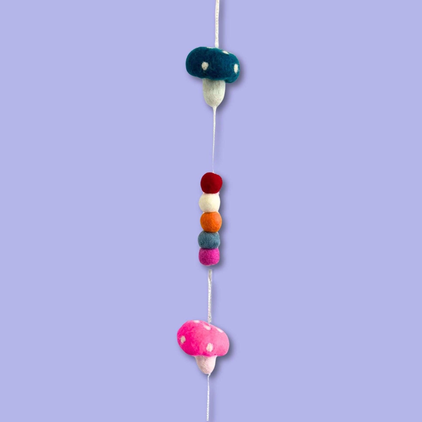 Felt Wall Hanging featuring colorful mushrooms and decorative felt beads on a pastel background.