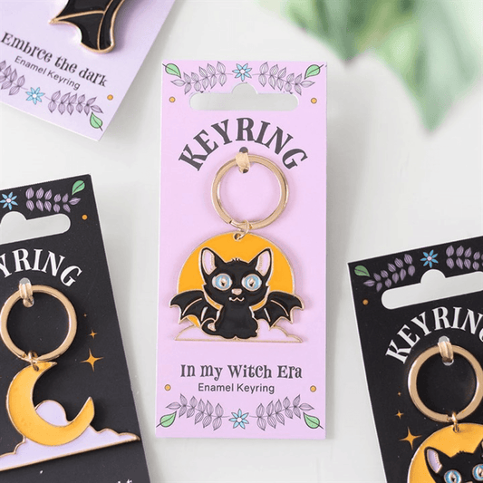 Keyring packaging with a black cat design on a white background